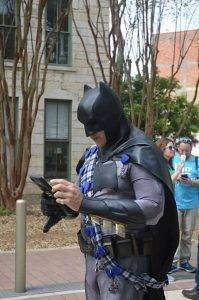 Batman checking his phone during Big Give Pep Rally