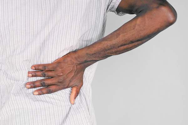 African American Male Grabbing Back for Kidney Pain