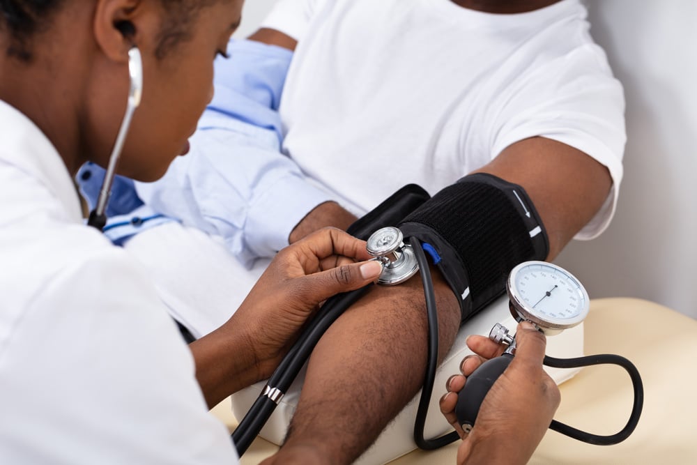 Doctor checking blood pressure of patient at South Texas Renal Care Group