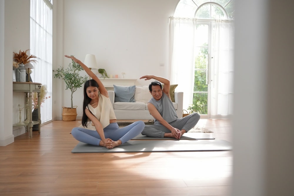 man and woman doing gentle yoga excercise