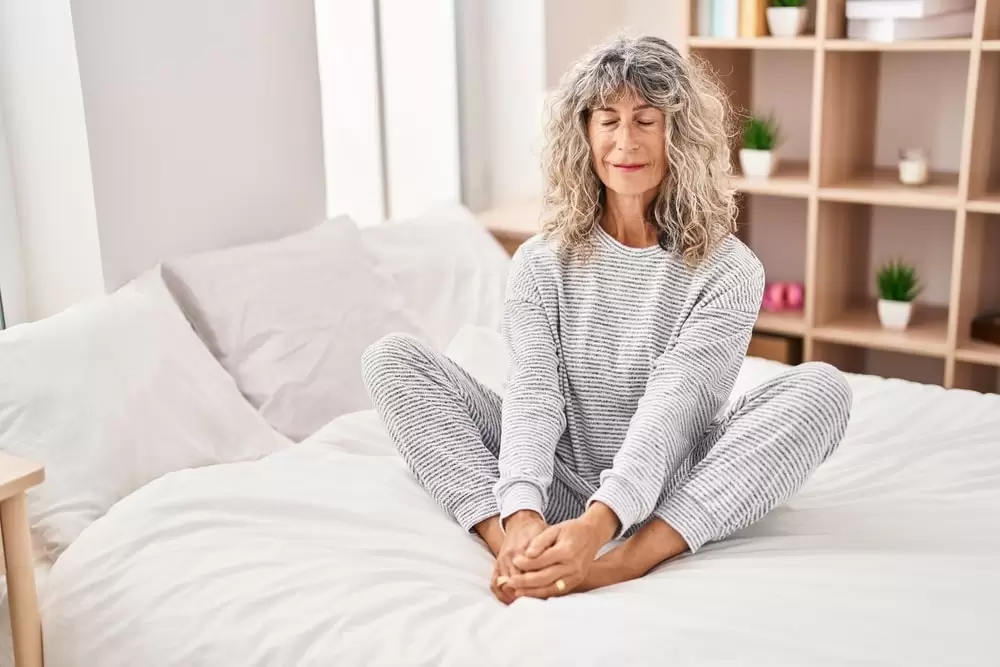 middle-aged woman doing gentle yoga stretch