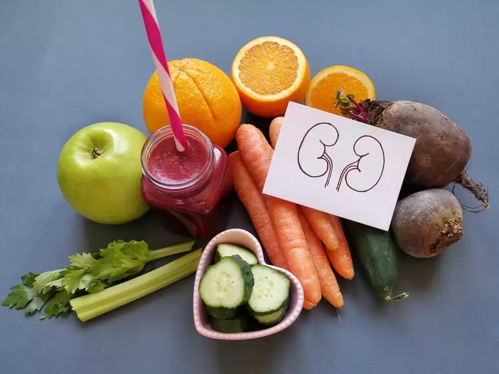 medly of vegetables, fruits and juices that support kidney health with cartoon drawing of kidneys